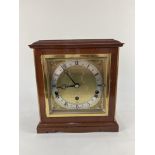 A mahogany cased Elliot mantle clock, the 5 1/2 inch square gilt dial with cherub spandrels,