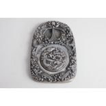 A Chinese metal plaque, cast with dragons with loose circular cover over well, character marks to