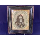 A embroidered panel depicting an oval miniature portrait of Charles II within a wreath of leaves,