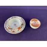 A Chinese porcelain teabowl and saucer, decorated in the Imari palette, (a/f) together with a sake