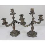 A pair of Rococo style bronzed metal three branch scroll candlesticks, 31.5cm high (a/f)