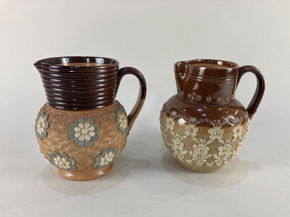 Two Doulton Lambeth pottery jugs, one with overlaid floral design by Annie Partridge, the other with