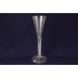 An 18th century wine glass, with trumpet bowl and air twist stem, on folded conical foot, 22.5cm