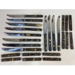 Twelve Japanese bronze and gilt handled table knives, together with twelve matching handles,