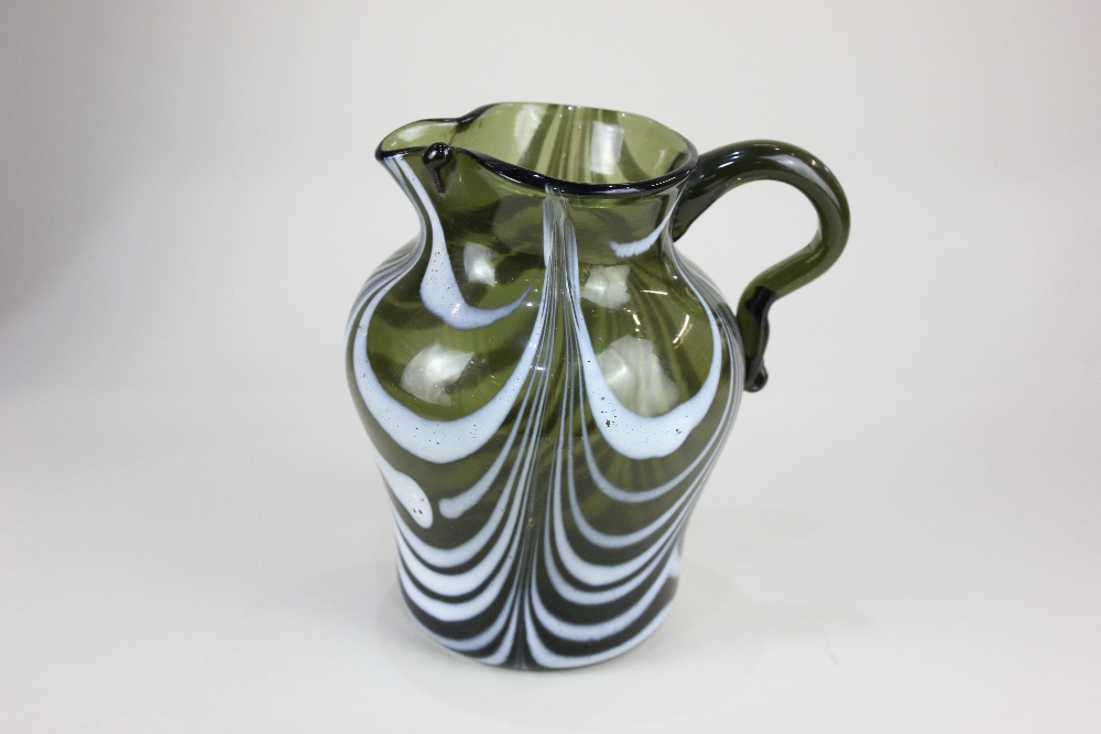 A late 18th / early 19th century Nailsea glass jug, in green with swirled white enamel stripes, 14cm