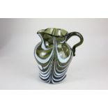 A late 18th / early 19th century Nailsea glass jug, in green with swirled white enamel stripes, 14cm
