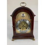 A modern reproduction mahogany cased bracket clock, the domed gilt face with silverised dial