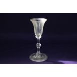 An 18th century wine glass, with waisted round funnel bowl, the stem with shoulder, centre and