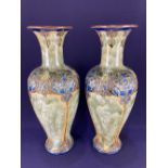 A pair of large Royal Doulton Art Nouveau stoneware vases, baluster shape decorated in relief with
