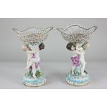 A pair of 19th century Berlin porcelain pierced pedestal dishes, the support modelled as two putti