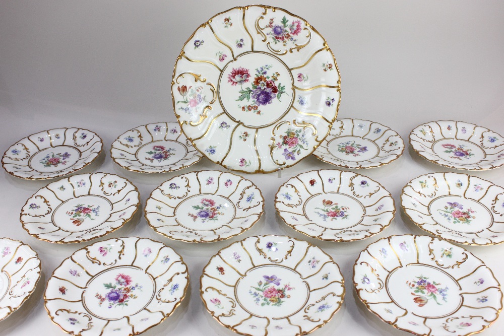 A collection of twelve Koenigszelt German porcelain plates, with floral decoration and scrolling