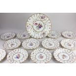 A collection of twelve Koenigszelt German porcelain plates, with floral decoration and scrolling