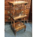 A Victorian rosewood three tier whatnot, with single shelf above drawer base, on turned supports and