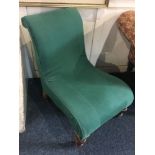 A Victorian green upholstered slipper chair, on turned legs and castors