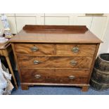 A 19th century mahogany chest of two short over two long graduated drawers with brass oval
