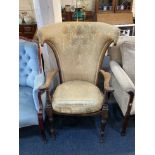 A Victorian wing back open armchair with solid seat on turned baluster legs