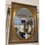 A modern rectangular gilt framed oval wall mirror with moulded scroll corners and border, 66cm