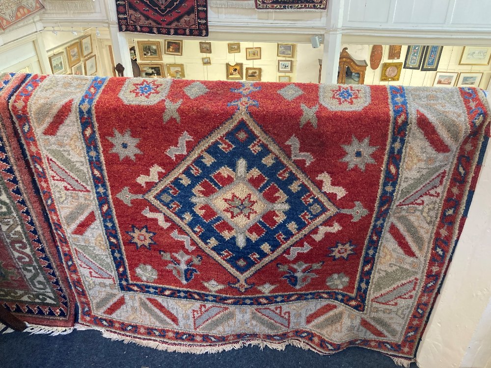 A Persian style rug, cream ground, with geometric decoration and two diamonds to the centre,