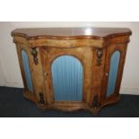 A Victorian walnut credenza, serpentine form with marquetry inlay, three arched doors with pleated