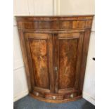 A George III mahogany bow fronted corner cabinet with double drawers and drawer below, 89cm