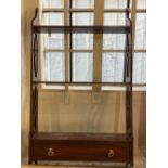 A mahogany three tier wall shelf with fretwork supports and lower single drawer, 41cm
