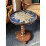 A Victorian rosewood wine table with floral tapestry insert and glass cover, on turned column to