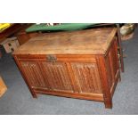 An oak coffer, with hinged lid above three linen fold carved panels on stile supports, 106cm (a/f,