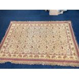 A possibly silk rug with all over floral scrolling design, within multi-line border, on cream