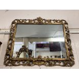 A giltwood rectangular wall mirror with pierced scroll surround, glass 50cm by 70cm