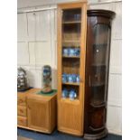 An Ercol pale wood narrrow glazed bookcase with single glass panelled door enclosing six shelves,
