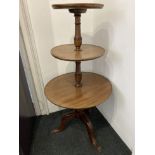 A 19th century mahogany three tier dumb waiter with three circular shelves on turned baluster