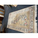 A Chinese wool rug the floral and bird design, within floral border on cream ground 151.5cm by 247cm