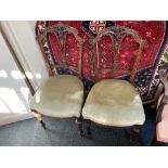 A pair of late 19th / early 20th century walnut occasional chairs with finely pierced backs
