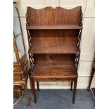 A Victorian mahogany three-tier waterfall bookcase with fretwork lattice supports and lower drawer