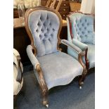A Victorian walnut open arm gentleman's chair with carved frame, upholstered seat, button back and