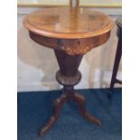 A Victorian walnut inlaid trumpet form sewing table, with hinged circular top enclosing a fitted