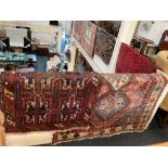 A Persian style rug, cream ground, with central panel of three diamonds amongst geometric designs,