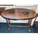 A Victorian walnut oval occasional table the top with two floral marquetry panels and ebonised