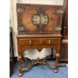 A reproduction William and Mary style metal mounted cabinet on stand the top with two cupboard doors