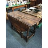 An 18th/19th century oak oval drop leaf table with block and turned gateleg base, (a/f) opens to