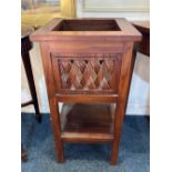 A reproduction square shaped jardiniere stand with pierced lattice sides and undershelf, plaque with