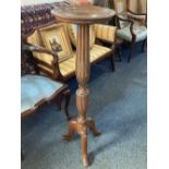 A mahogany carved jardiniere stand with fluted stem and foliate decoration on tripod base, (a/f)