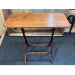 A mahogany coaching table, the rectangular top with canted corners, on folding frame, 76cm