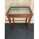 A carved vitrine display cabinet rectangular rising top (glass broken) with ornately carved sides