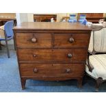 A George III mahogany flat front chest of two short over two long drawers, with turned knob handles,