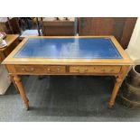 A Victorian satinwood rectangular writing table with leather inset top above two drawers, on