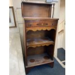 A small mahogany bookcase with raised shelf back, single inlaid drawer above two open shelves on