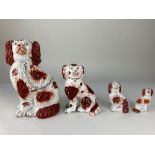 A collection of four 19th century Staffordshire pottery spaniels, of different sizes and styles,