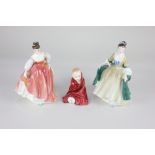 A Royal Doulton porcelain figure of a child wrapped in a blanket, 'This Little Pig', 10.5cm high,