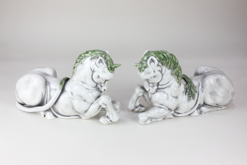 A pair of Continental ceramic models of unicorns, with green and grey glaze, each marked Italy 105 /